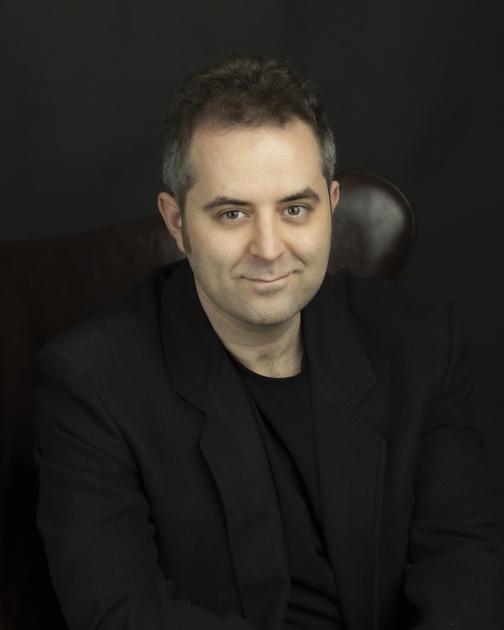 Ben Moskowitz, seated in a leather chair